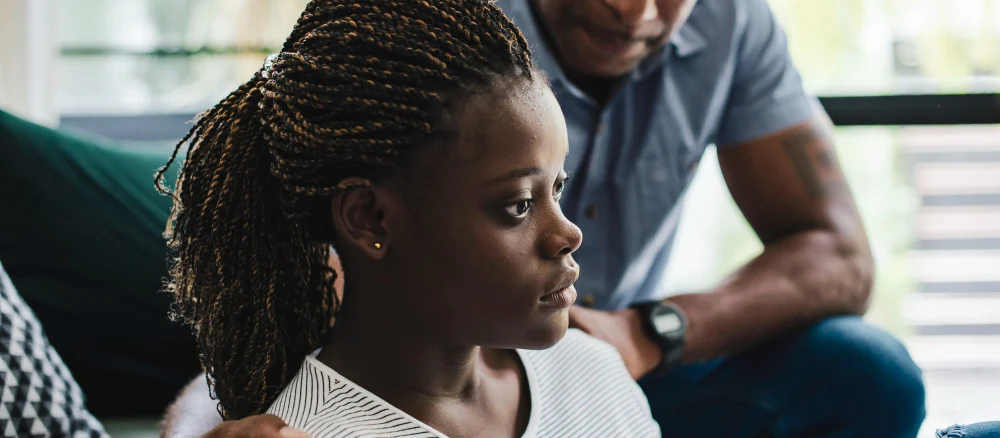 father consoling his depressed daughter