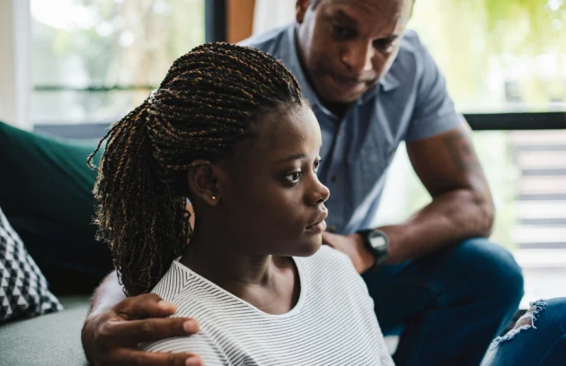 father consoling his depressed daughter