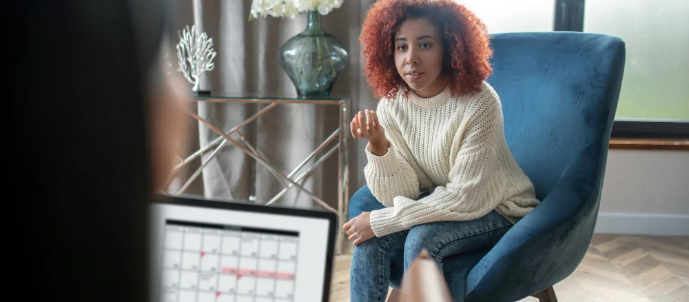 Young curly woman talking to her psychotherapist