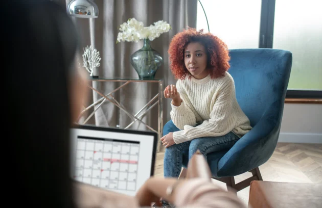 Young curly woman talking to her psychotherapist