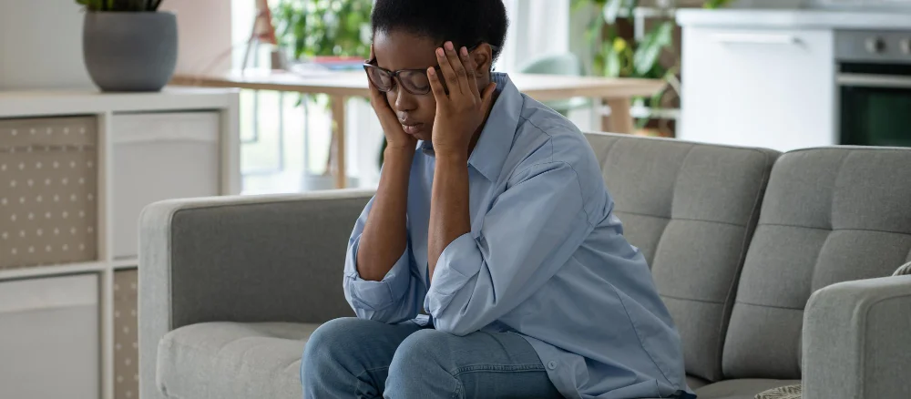 discouraged-sad-african-american-woman-sits-sofa-feeling-stressed-because-loneliness