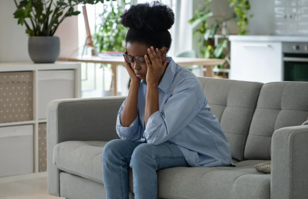 discouraged-sad-african-american-woman-sits-sofa-feeling-stressed-because-loneliness