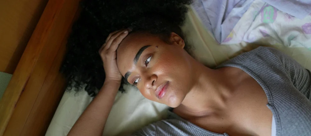 African American woman feeling Insomnia in bed