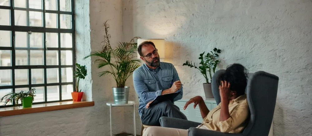 Caring counselor listening to female patient